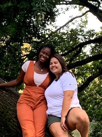 Apenteng and exchange student Mia Ola pose for a photo by a tree.